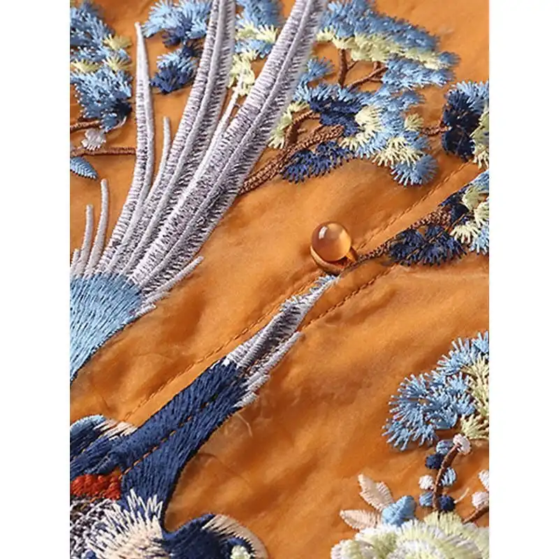 Back view of embroidered Tang vest highlighting detailed needlework patterns and tailored construction.