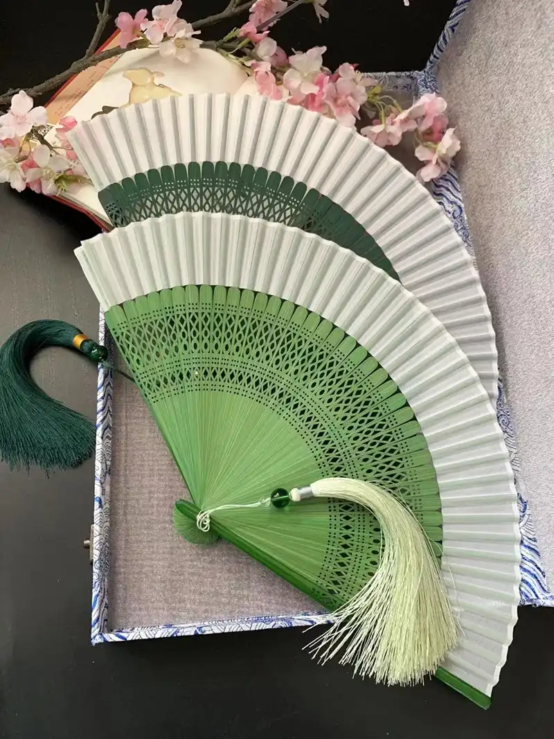 Traditional cultural celebration featuring ancient style folding fans as ceremonial props.