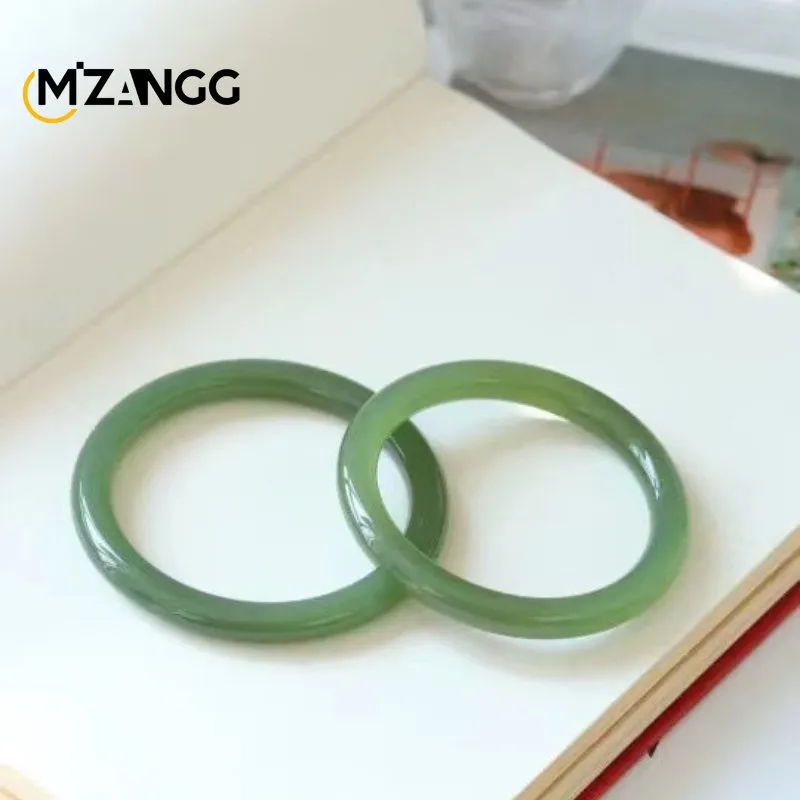 Natural jade bangle comparison showing duck egg green color variations and authentic stone patterns.