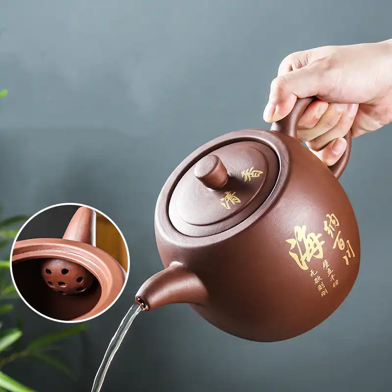 Handmade Yixing teapot spout detail showing smooth purple clay finish and precise construction.