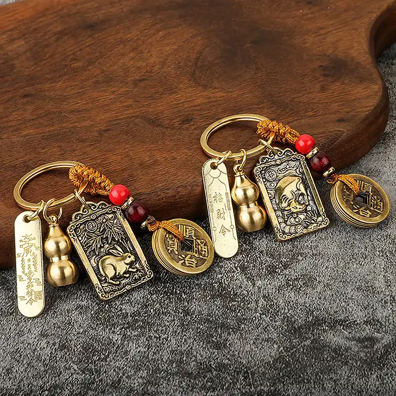 Traditional Chinese five emperors money keychain displaying authentic coin inscriptions and craftsmanship.