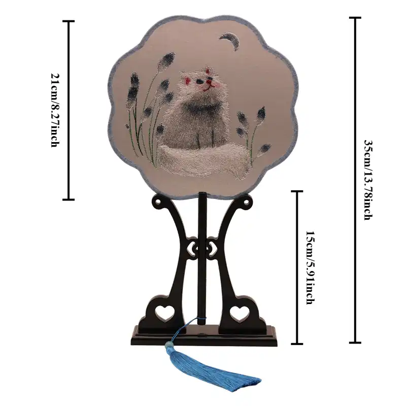 Suzhou embroidery folding fan in closed position demonstrating compact portable design for hanfu.