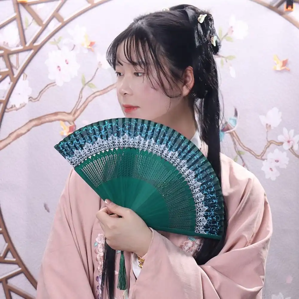 Close-up view of bamboo ribs and silk covering highlighting premium construction quality of fan.