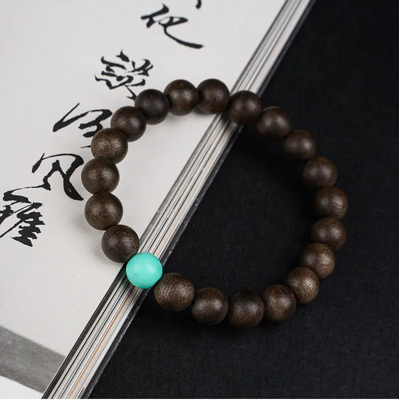 Natural wooden bracelet packaging showing authentic Kyara agarwood bead quality.