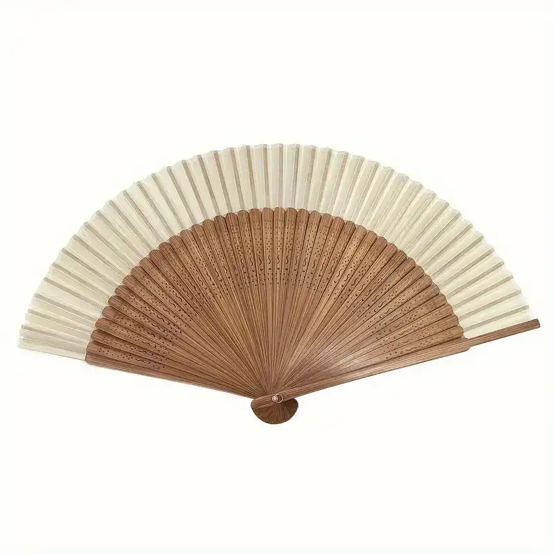 Closed heart shaped Chinese fan showing compact portable design and bamboo material quality.