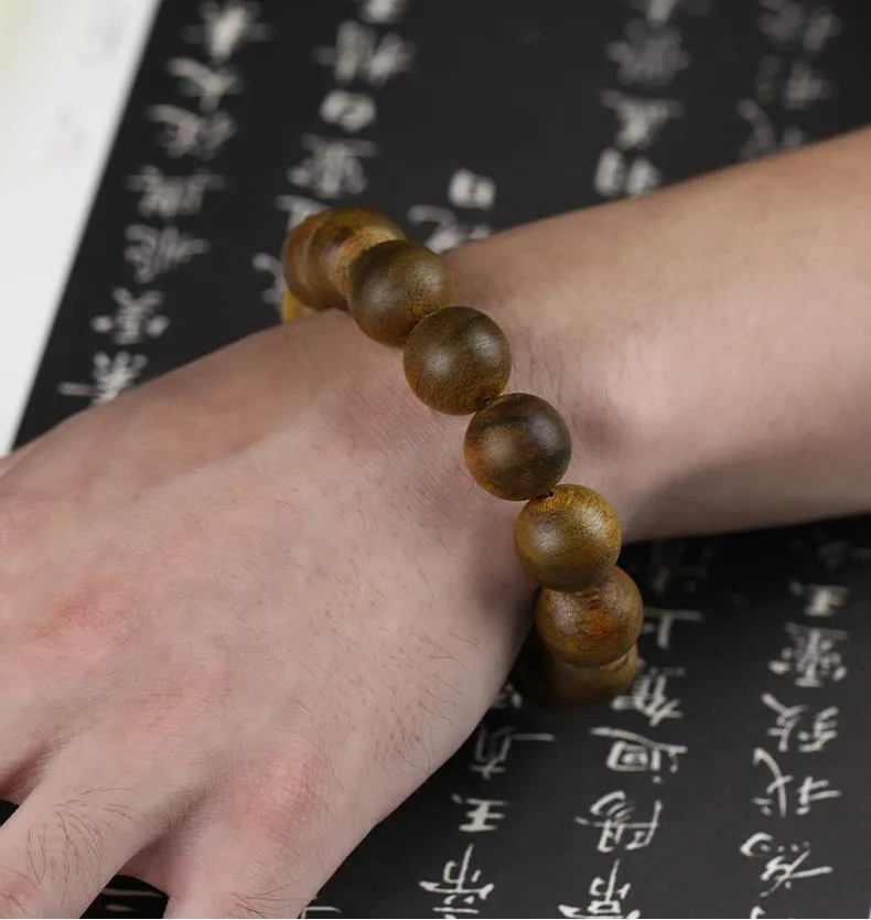 Natural Nha Trang agarwood beads bracelet lifestyle photo with meditation cushion and incense.