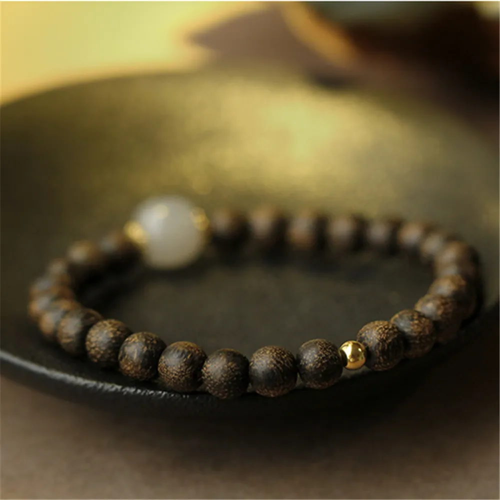 Gift packaging presentation of agarwood Buddha bracelet ready for spiritual jewelry gifting.
