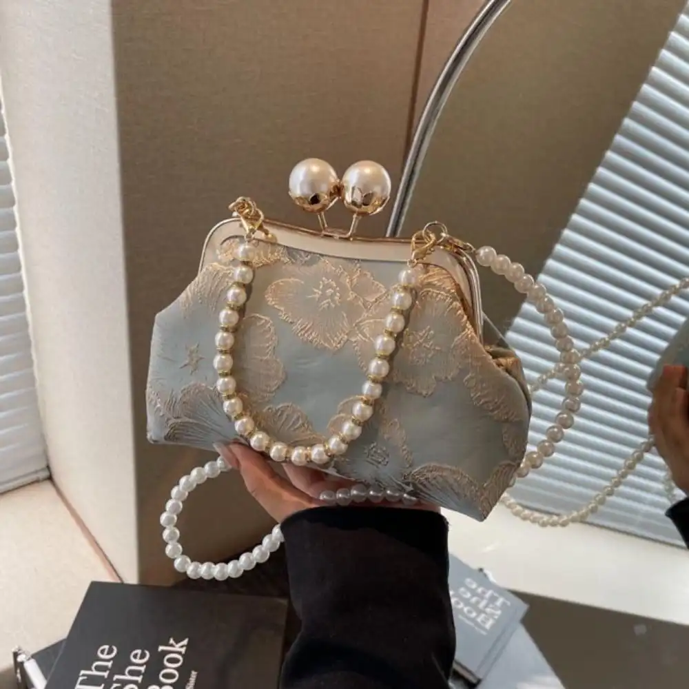Flat lay styling of clutch bag with traditional Chinese accessories and jewelry.