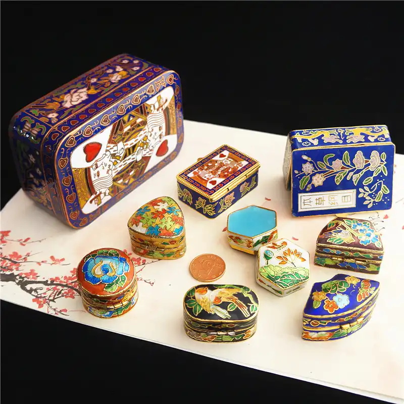 Decorative display setup featuring vintage cloisonne box as collectible art piece centerpiece.