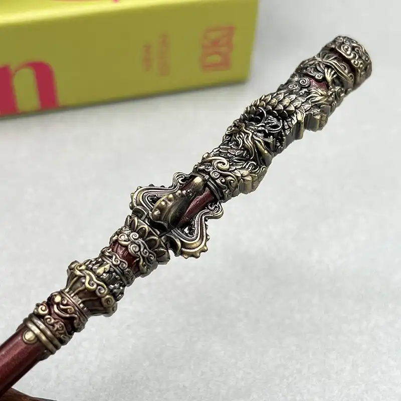 Black Myth Wukong staff model displayed on desk setup with gaming accessories