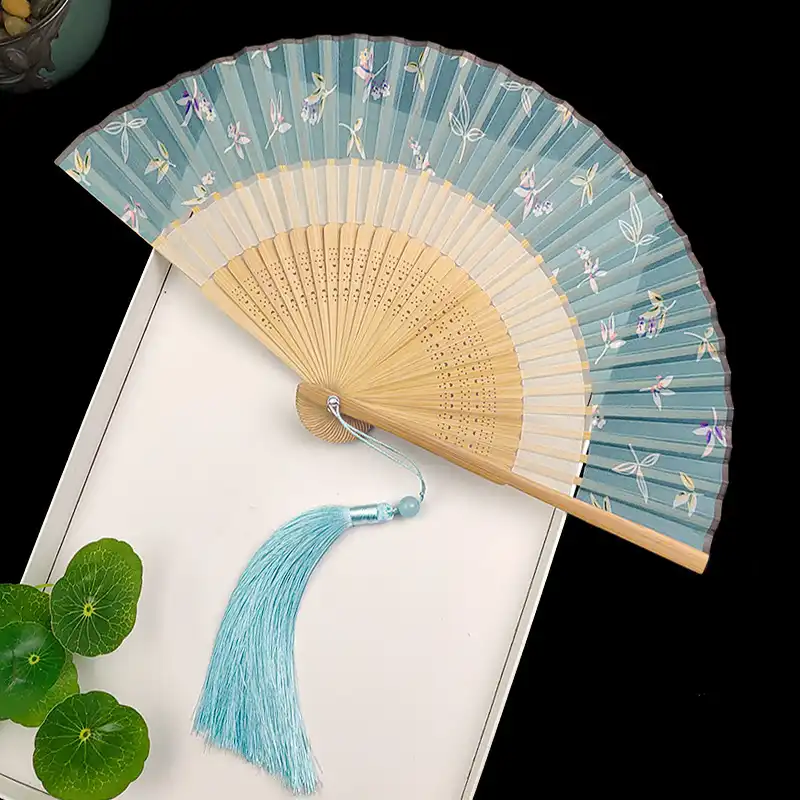 Party celebration featuring vintage silk fans as decorative elements and guest accessories.