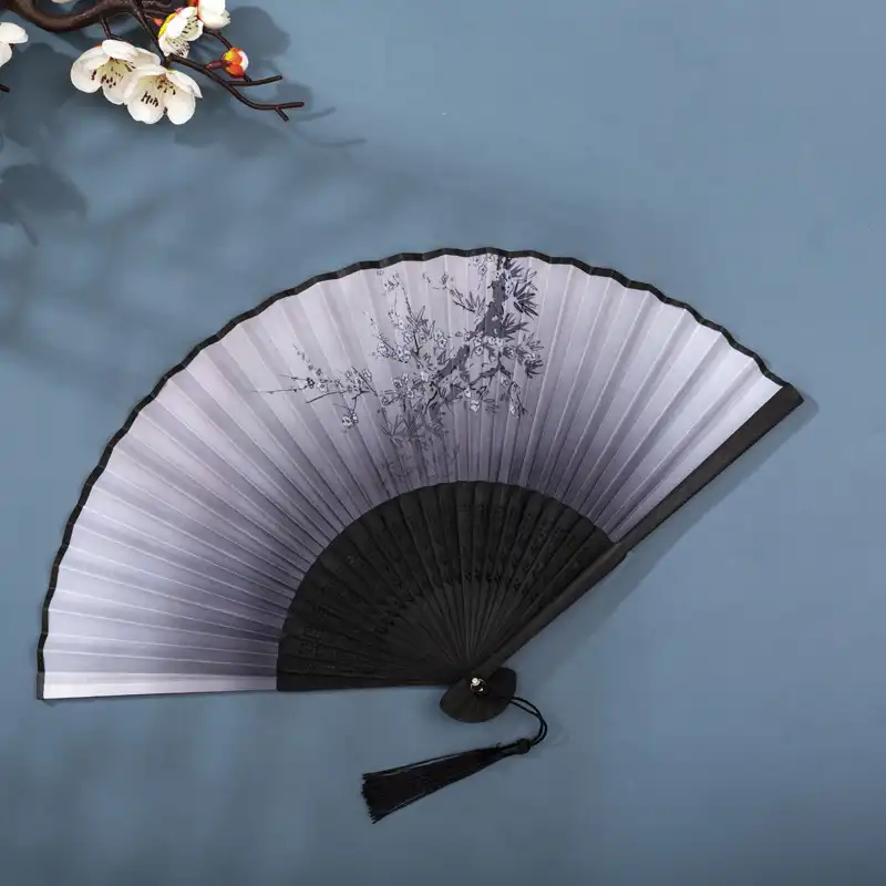 Traditional costume ensemble featuring folding fan as authentic cultural accessory piece.