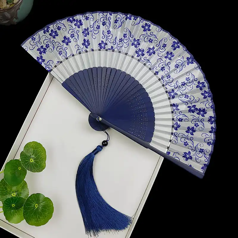 Traditional art craft demonstration of Japanese folding fan construction techniques.