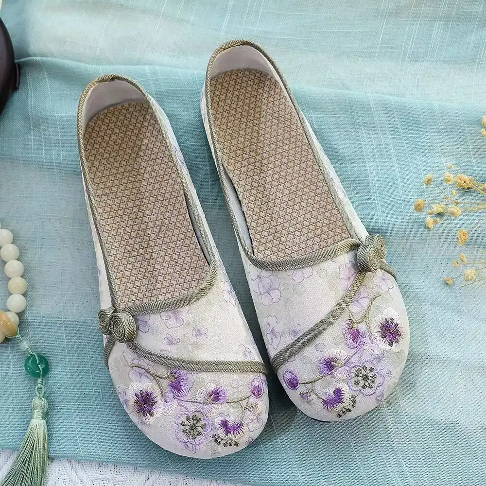Comfortable slip-on design demonstration of Old Beijing cloth shoes easy wearing process.