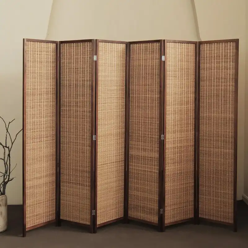 Natural bamboo screen divider positioned in bedroom showing versatile home decoration use.