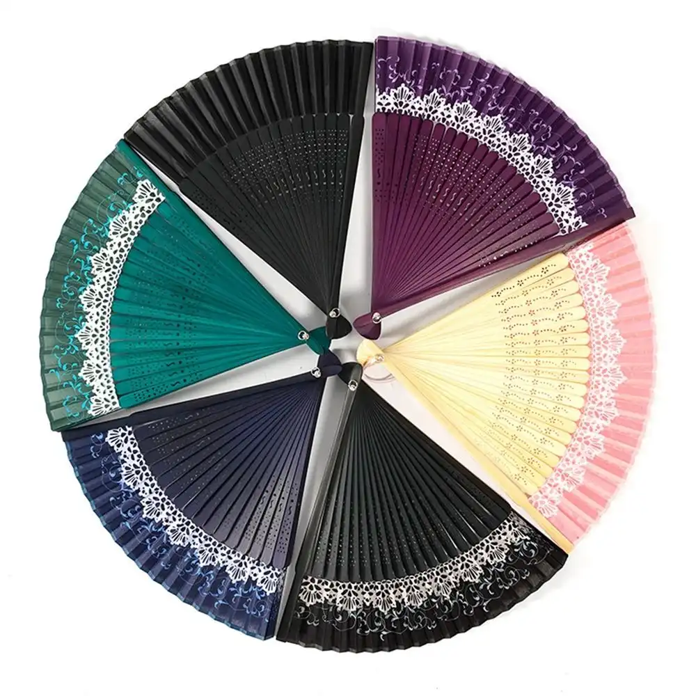 Professional dancer performing with Japanese color changing folding fan in outdoor setting.