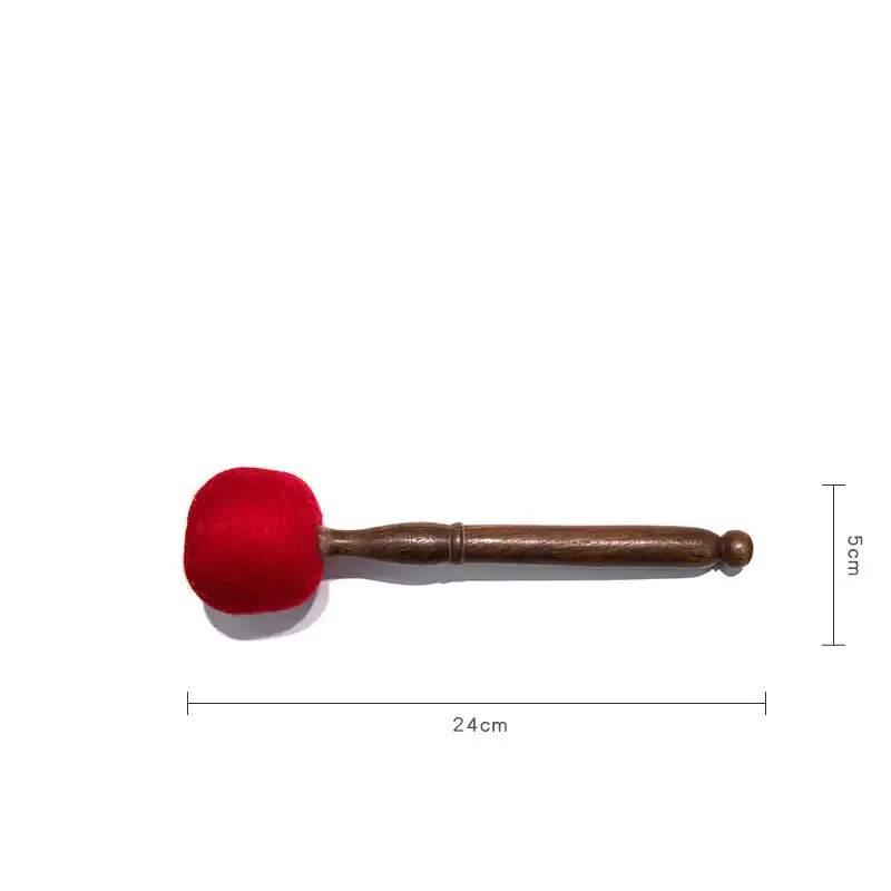 Hand holding wooden striker showing comfortable grip and balanced weight distribution.