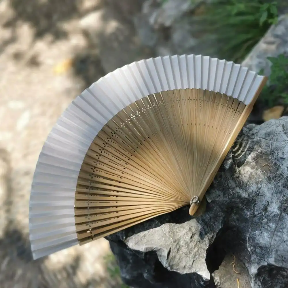 Handmade construction process detail showing bamboo and silk assembly techniques.
