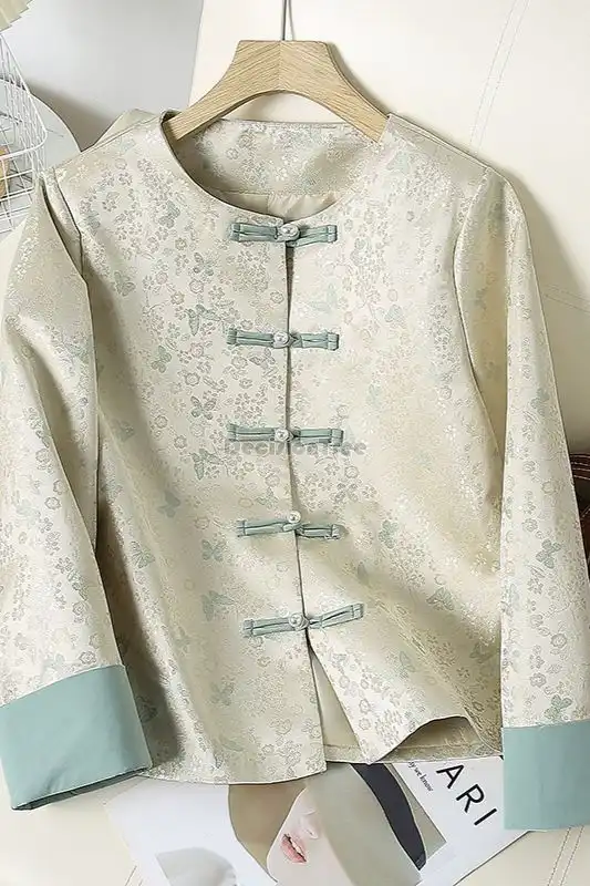 Model wearing modern tang suit shirt with lapel collar and long sleeves in professional setting.
