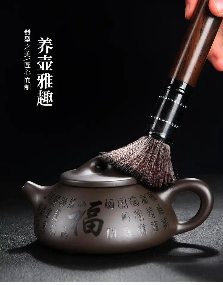 Close-up of Yixing teapot spout and handle showing precise handcrafted construction and smooth curves.