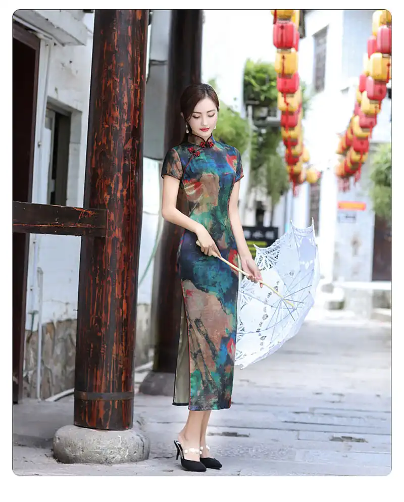Model wearing long qipao in cultural setting demonstrating traditional heritage styling.