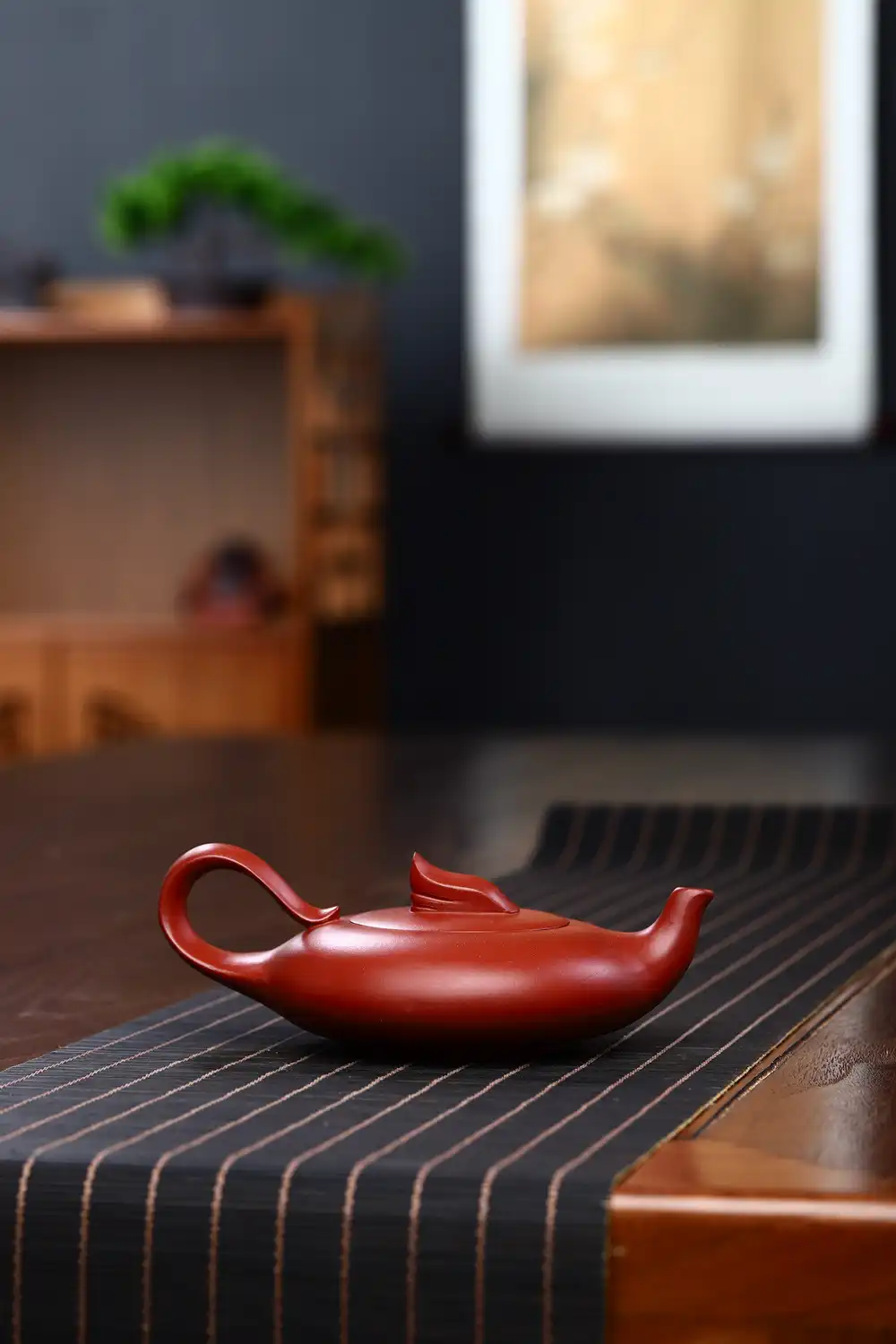 Handmade Yixing teapot spout and handle detail displaying traditional craftsmanship and smooth finish.