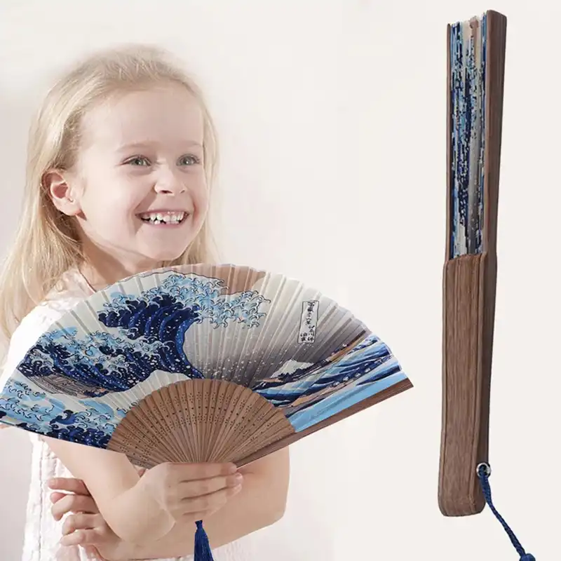 Close-up of fan handle showing smooth bamboo construction and traditional Japanese craftsmanship details.