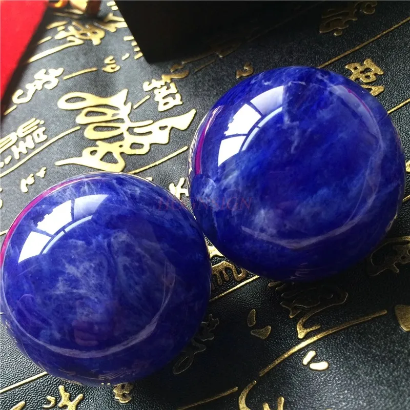 Size comparison showing 5cm diameter Baoding balls perfect fit for adult hands during exercise.