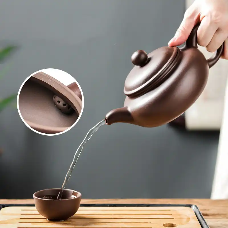 Complete antique tea set arrangement featuring Xishi teapot with cups on wooden serving tray.