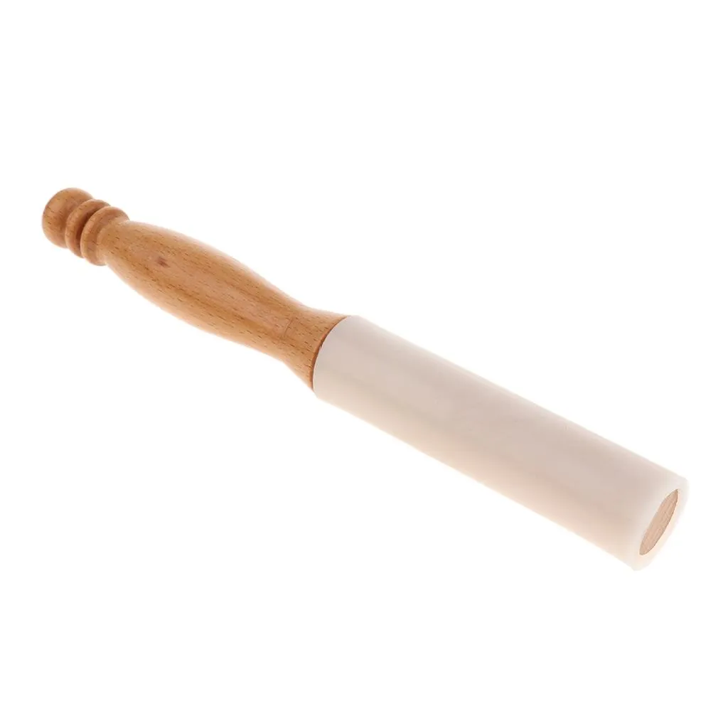 Professional sound healer using rubber mallet during crystal bowl therapy session.