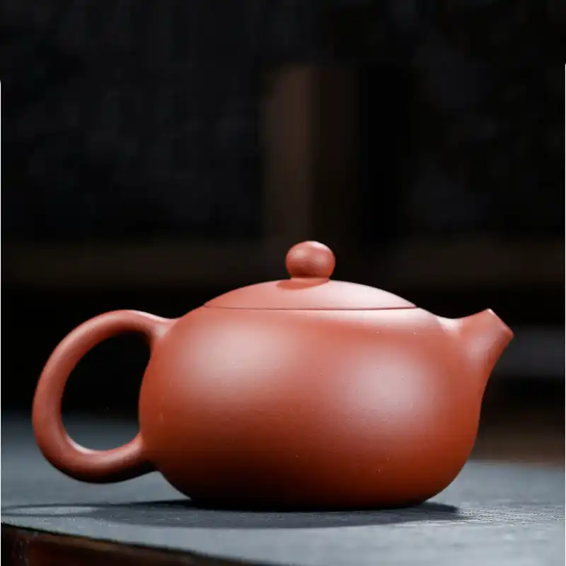 Complete teaware set featuring Yixing teapot with tea cups arranged on bamboo tray setting.