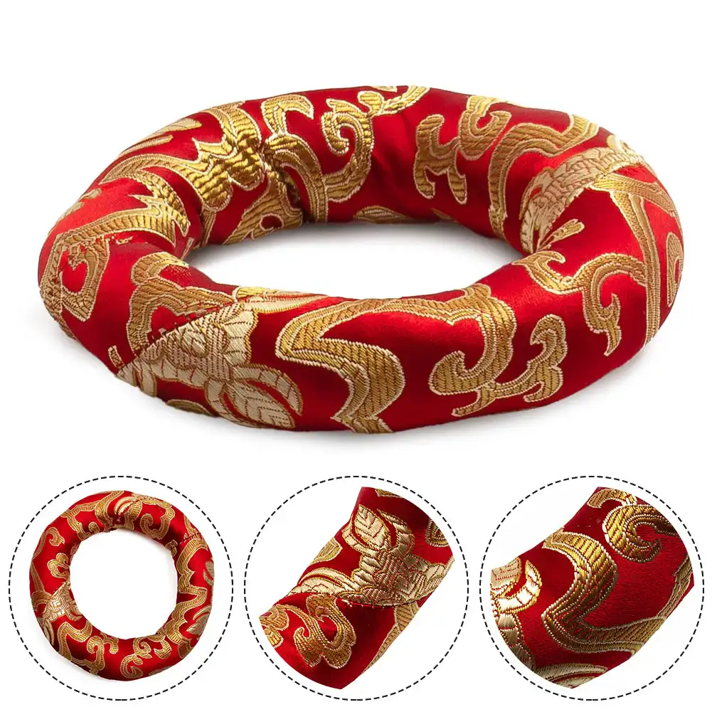 Traditional Buddhist meditation setup with brocade cushion supporting singing bowl on altar.