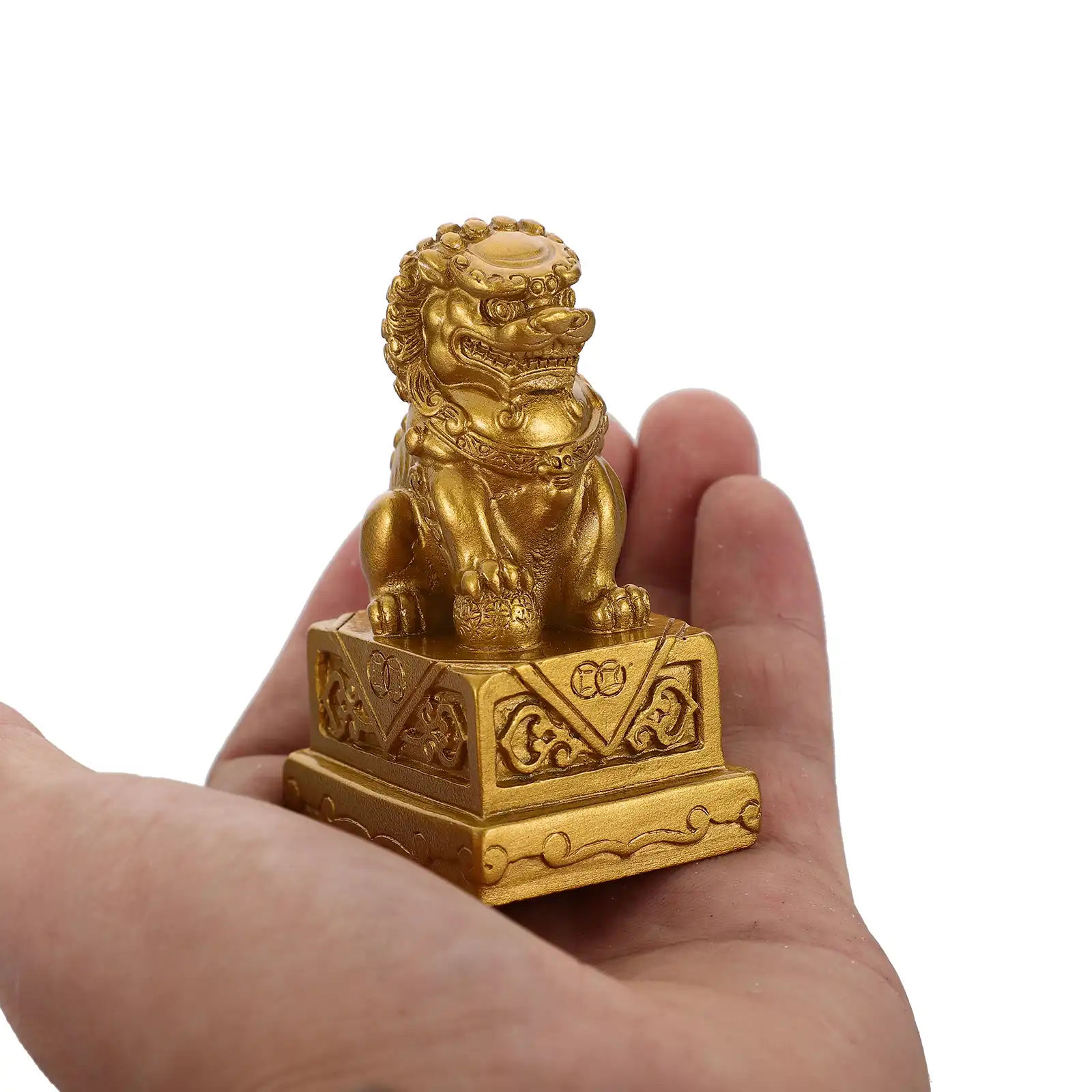 Pair of golden resin lion figurines arranged on modern shelf showcasing home decor styling possibilities.