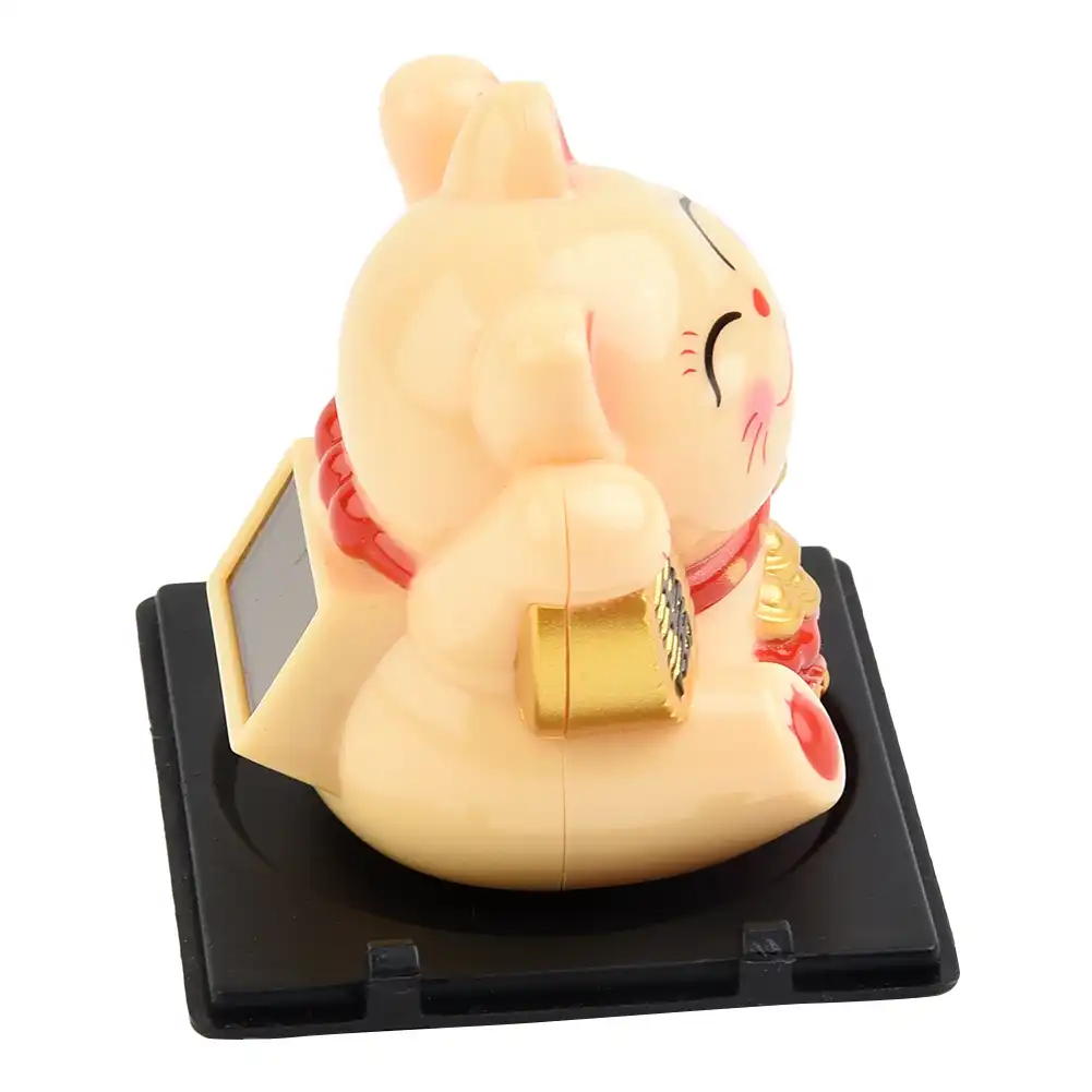 Lucky cat dashboard ornament demonstrating compact size perfect for small spaces.
