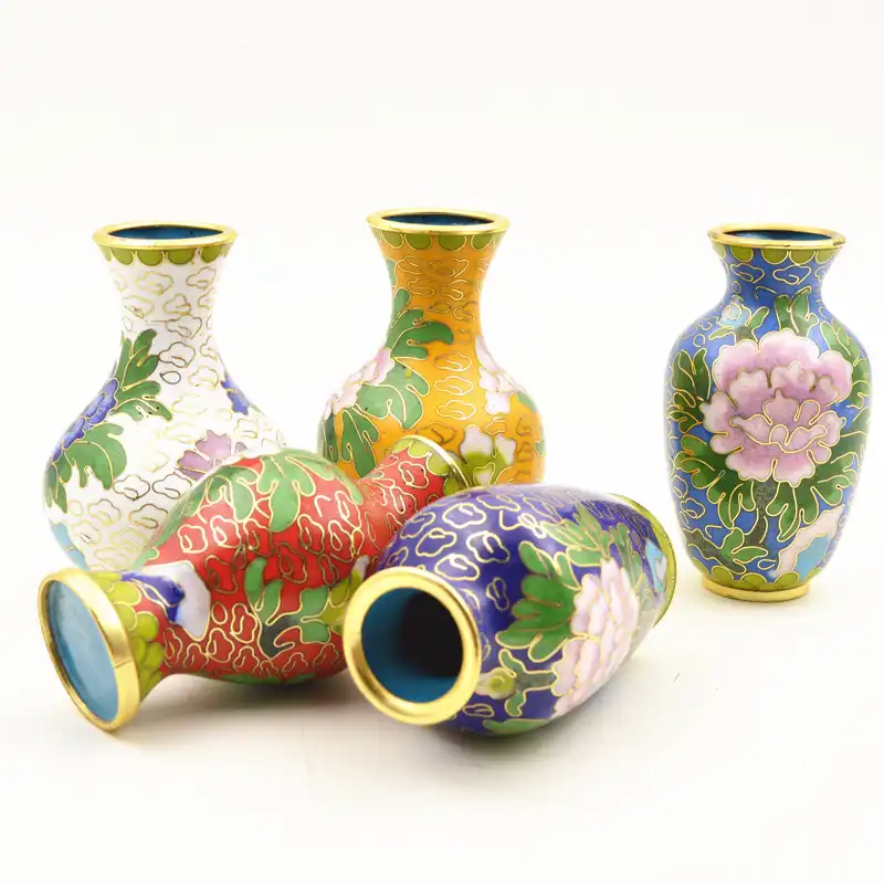 Handcrafted cloisonne vases arranged as home decor displaying cultural heritage artistry.