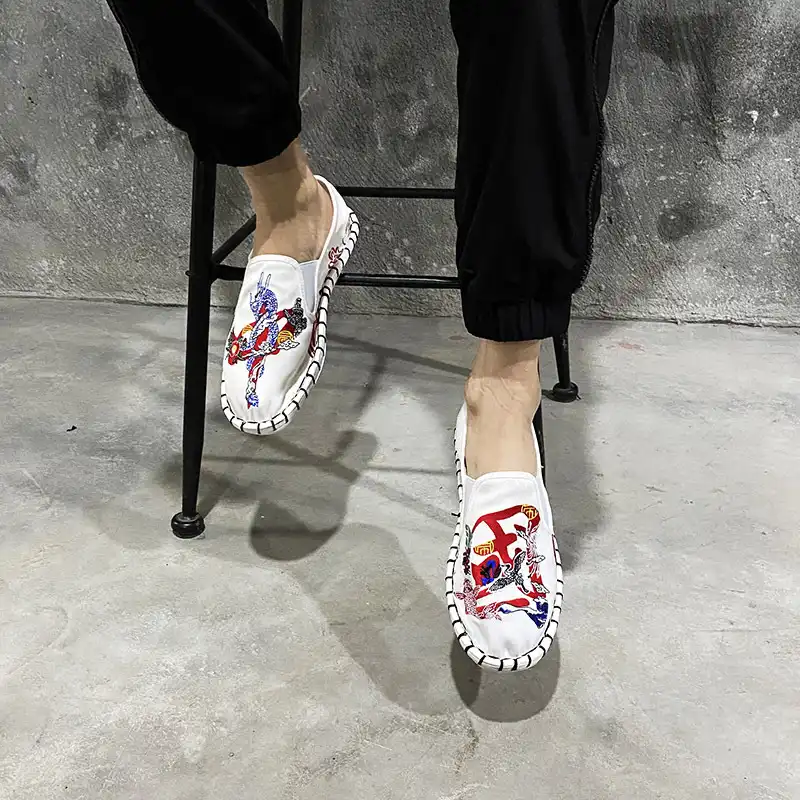 Traditional Chinese embroidered shoes displayed with cultural accessories and decorative elements.