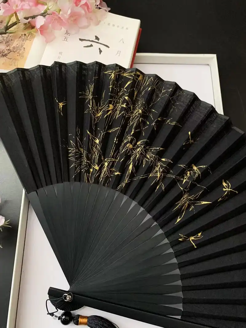Portable design of large Japanese folding fan folded to compact 25.5cm carrying size.