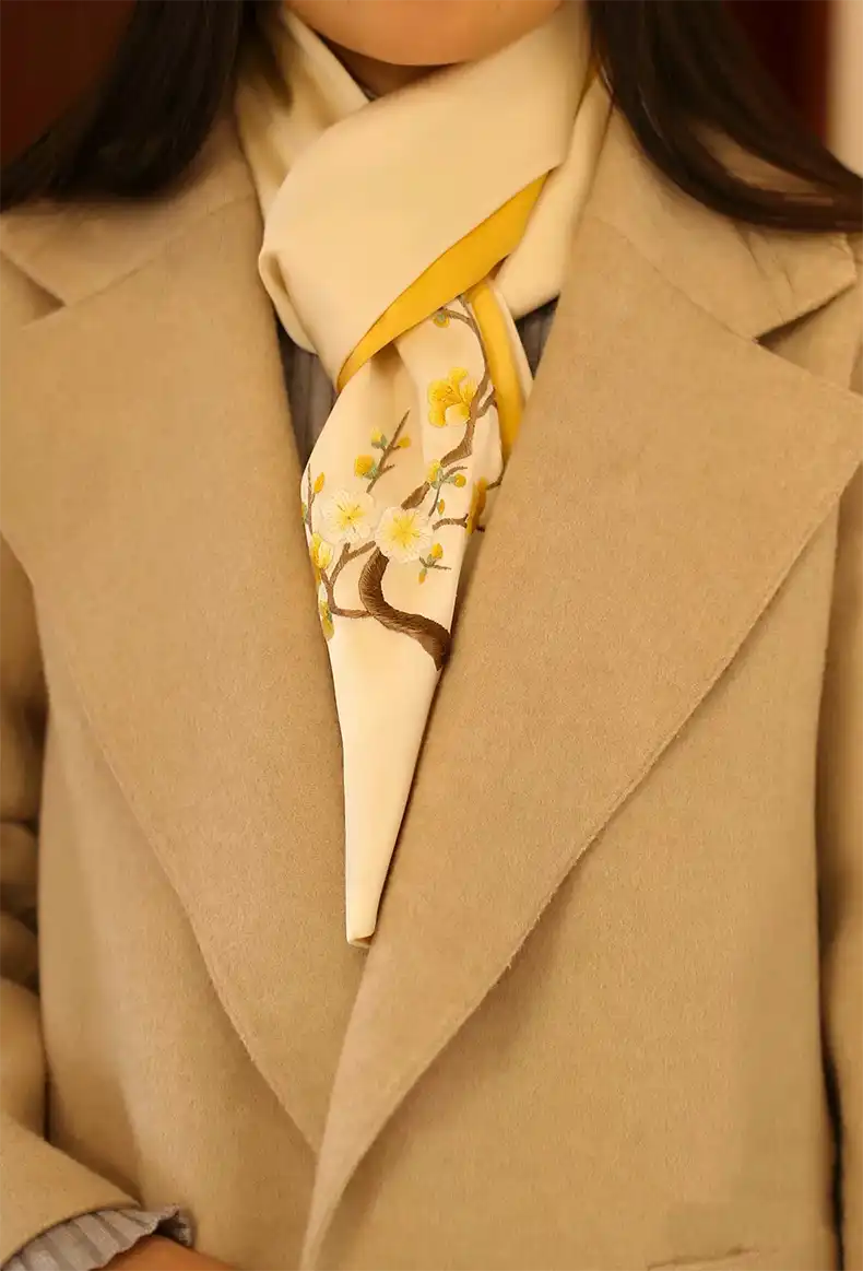 Premium silk shawl texture and embroidery detail highlighting handmade craftsmanship quality.