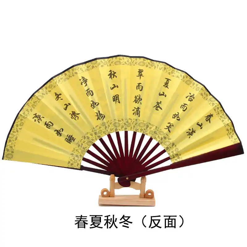 Person using bamboo fan for cooling demonstrating practical functionality during warm weather conditions.