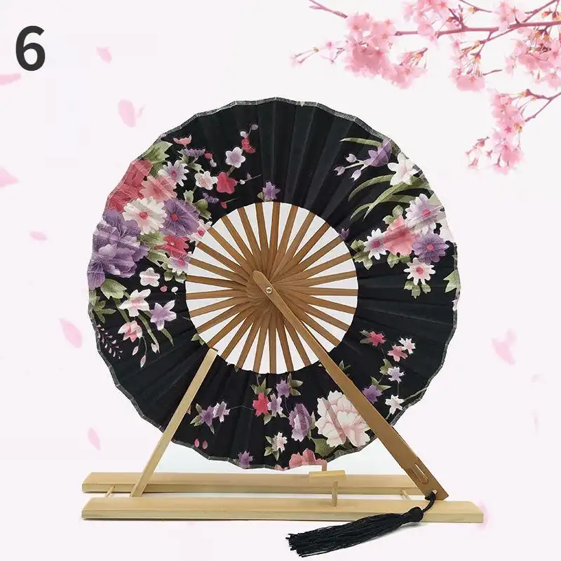 Japanese round folding fan in compact folded position showing portable 21cm size.
