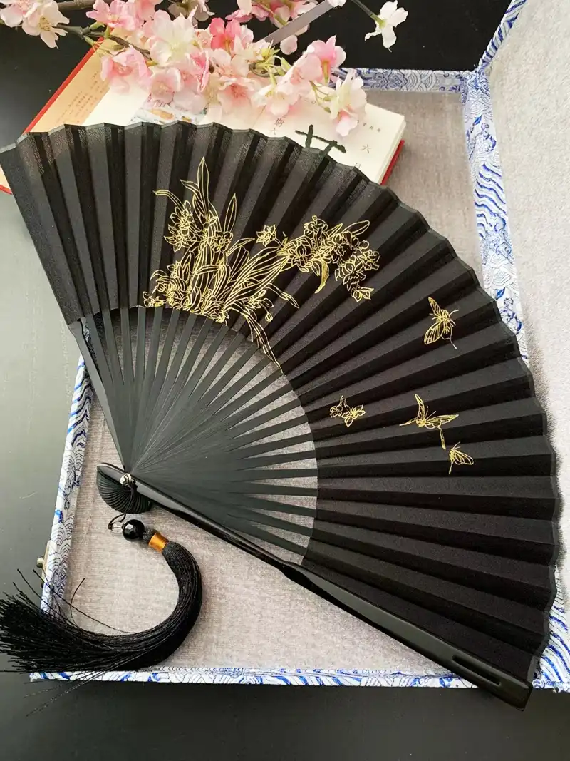 Professional man using large 8-inch Japanese folding fan for effective summer cooling.