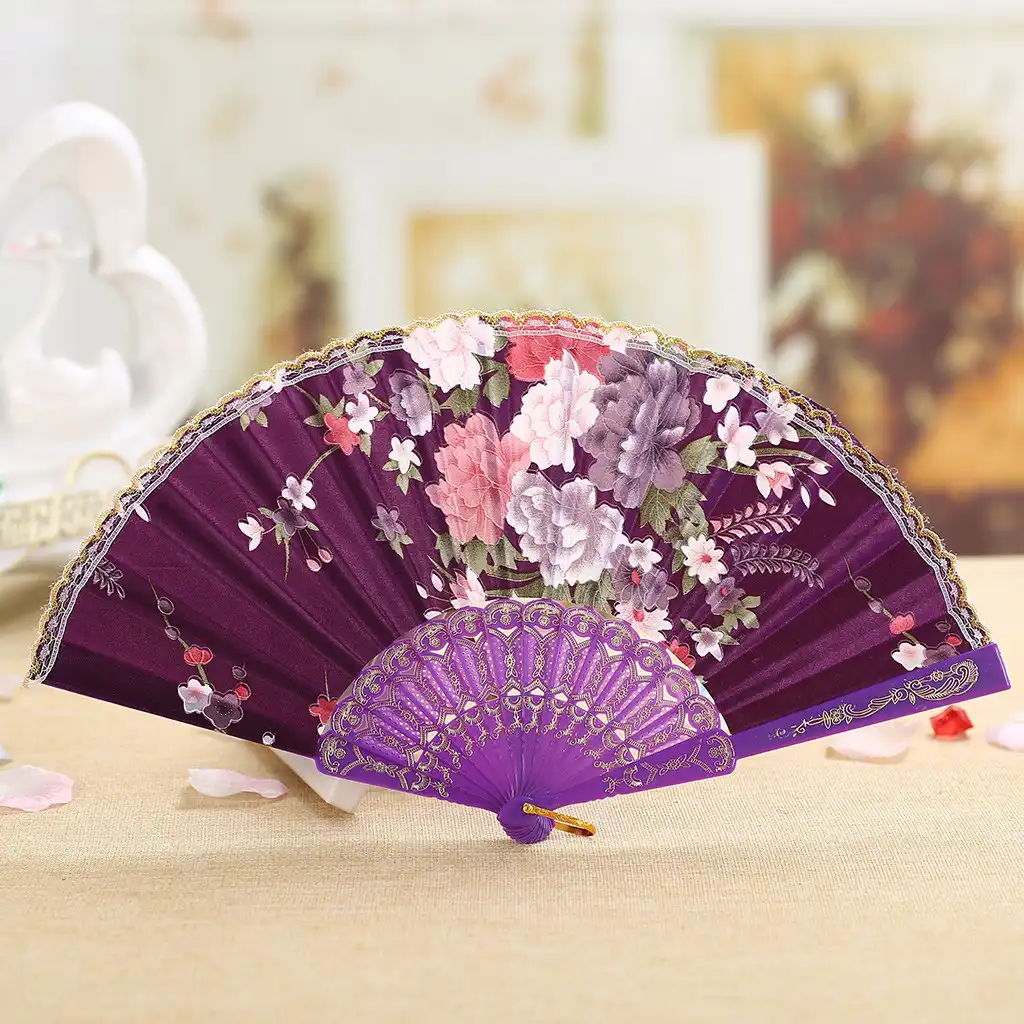 Elegant woman holding Japanese silk folding fan in traditional dancing pose demonstration.