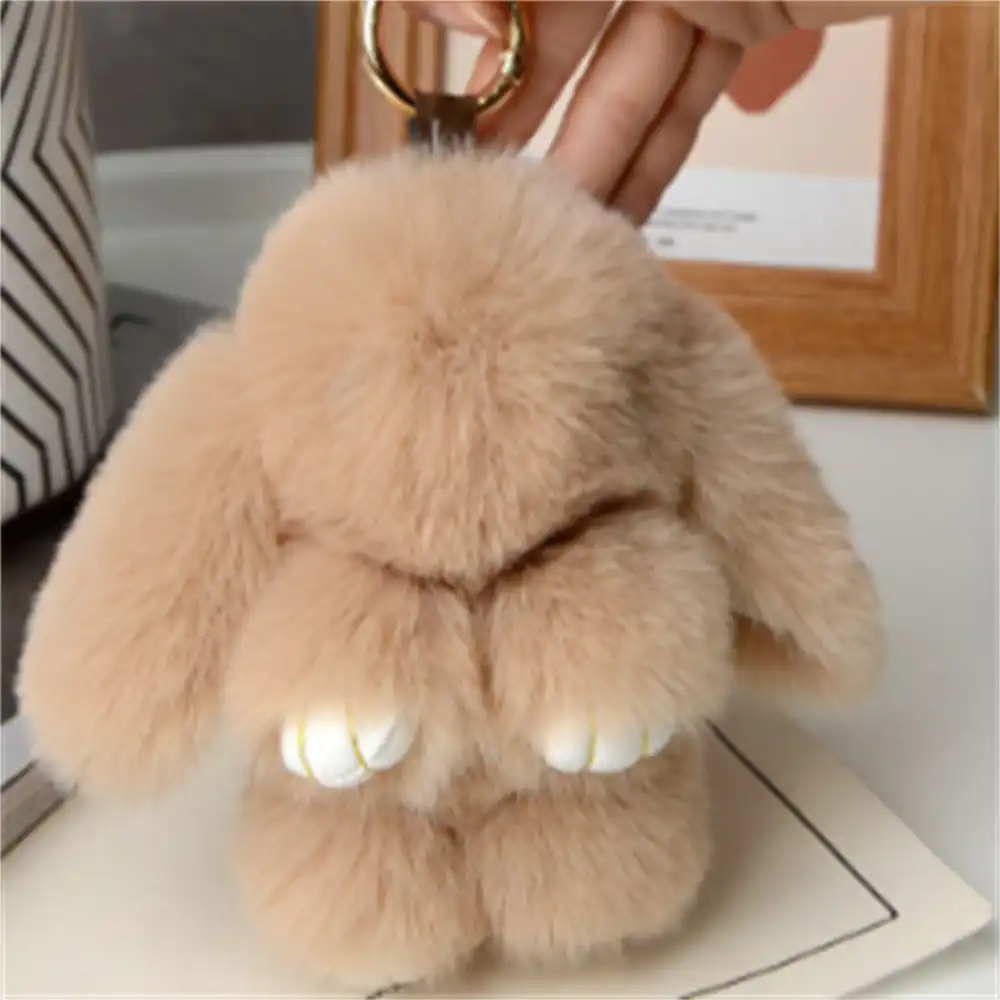 Side angle of rabbit fur keychain showing 15cm length and secure O-shaped buckle attachment.
