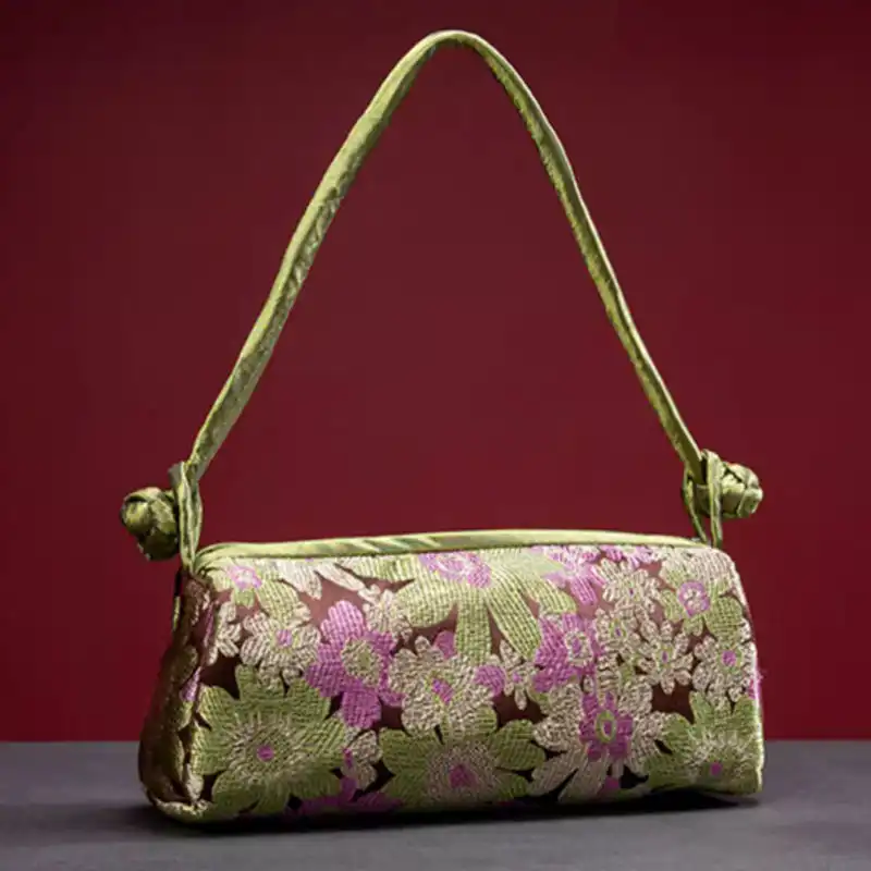 Evening event styling with silk embroidered bag paired with formal attire and jewelry accessories.
