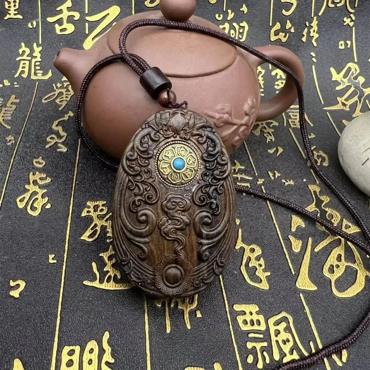 Back view of sandalwood Tathagata Buddha pendant showing smooth finish and natural grain.