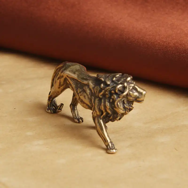 Packaging and presentation of vintage brass lion miniature figurine for gifting.