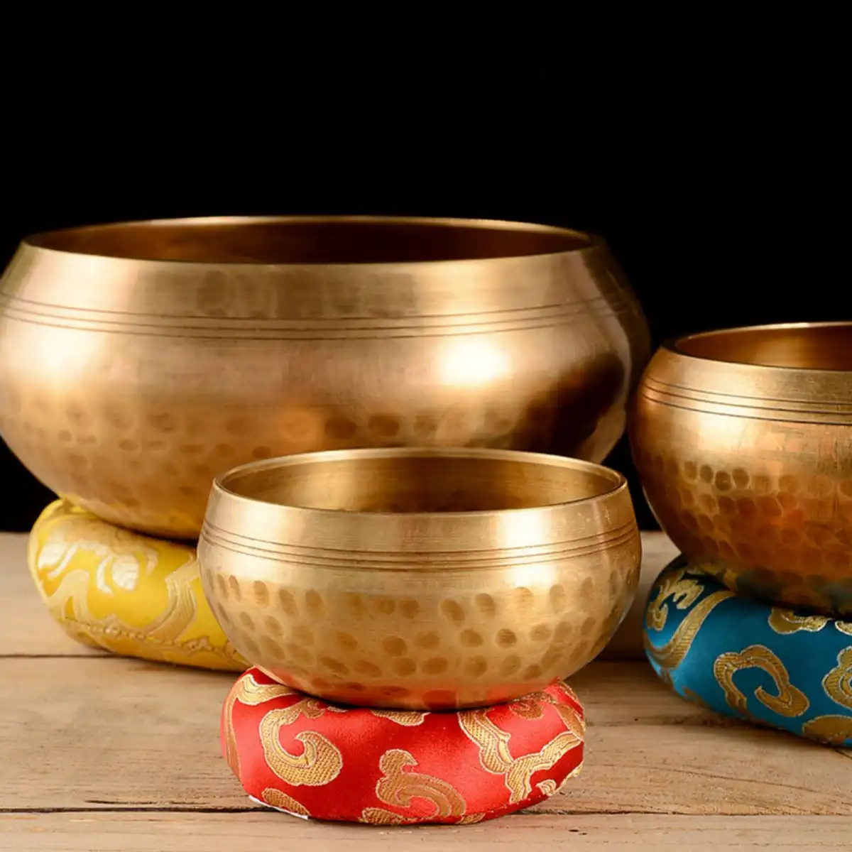 Professional sound therapy session using Tibetan singing bowl for chakra healing.