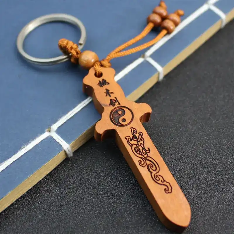 Peach wood sword keychain used as home decoration pendant showing versatile display options.