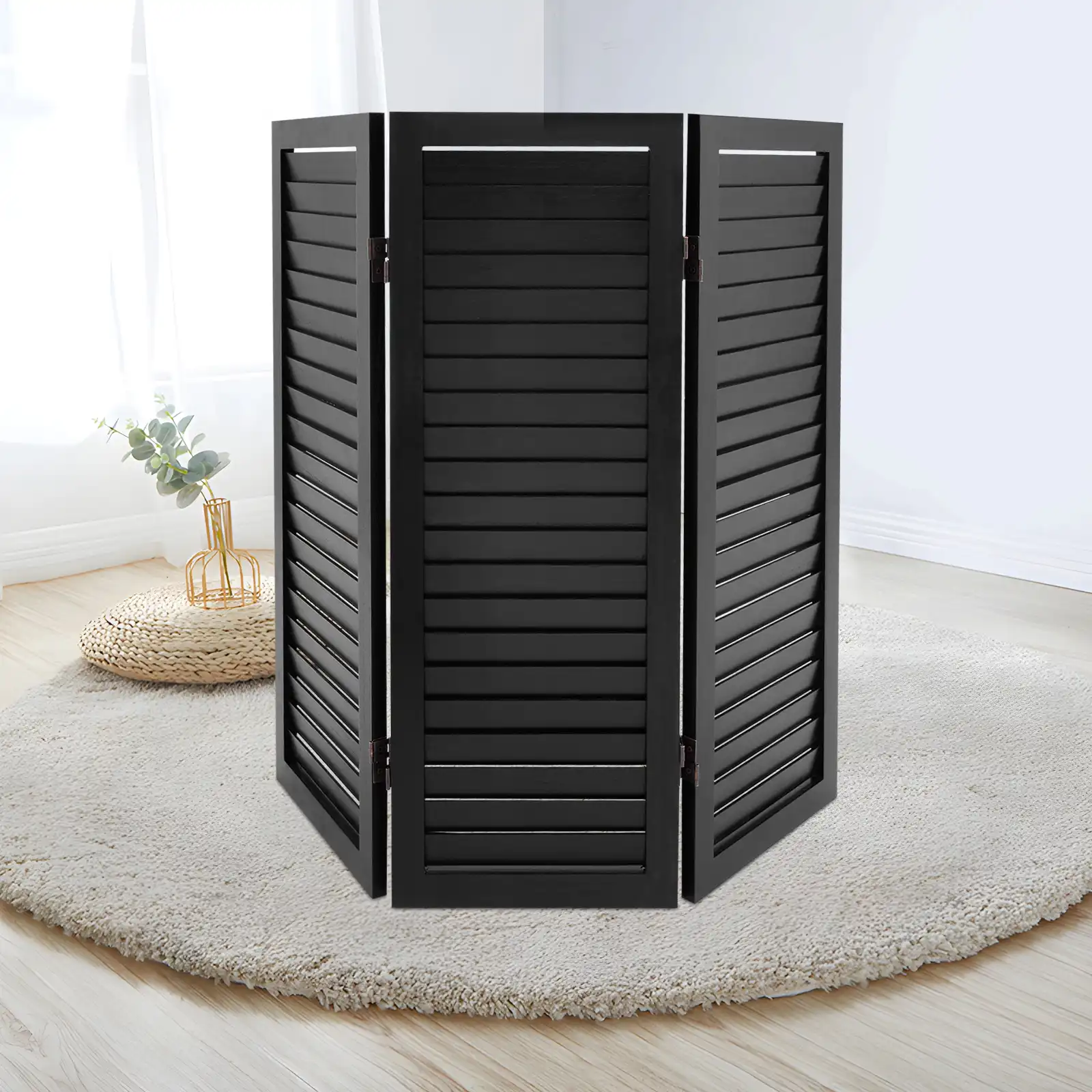 Chinese folding screen divider placed by window filtering light through shutter panels.