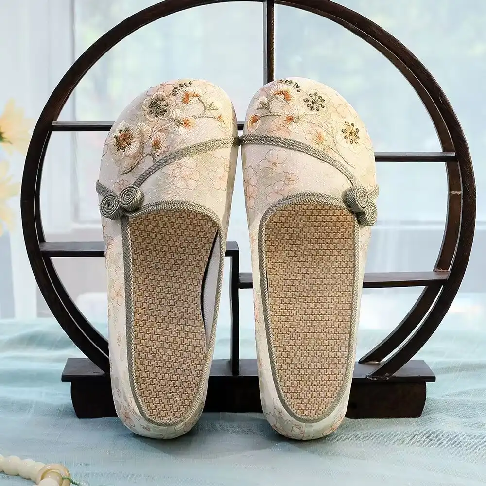 Lifestyle image of woman walking comfortably in traditional Chinese embroidered cloth shoes.